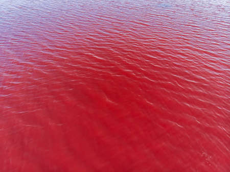 Aerial View of red Lake Surface in Ukraine Odessa, Kuyalnik liman red water from aboveの写真素材