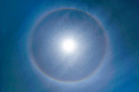 Fantastic Beautiful Sun Halo Phenomenon in the sky. Rainbow Ring around Sun in Summer