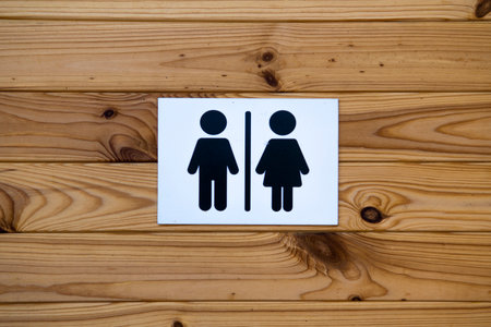 Toilet Sign on wooden wall background. Ecotoiletの写真素材