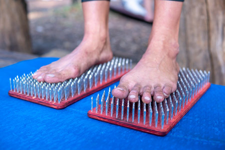 Women feet are standing on a board with sharp nails, Sadhu Boardの写真素材