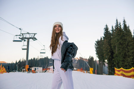 Portrait of Beautiful Cheerful Caucasian Girl On Ski Resort at Winterの写真素材
