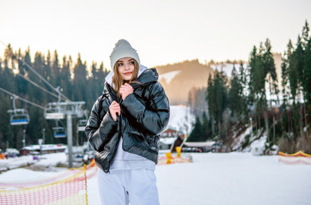 Portrait of Beautiful Cheerful Caucasian Girl On Ski Resort at Winterの写真素材
