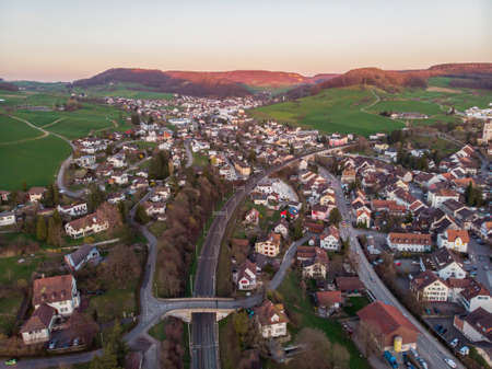 Aerial Shot of Common Swiss village, Canton Bern, Switzerland, Europe, autumn trees and mountains panoramaの写真素材