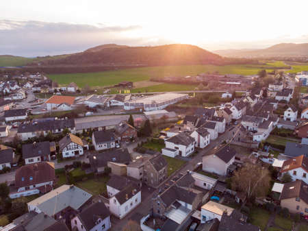 Aerial Shot of Common Swiss village, Canton Bern, Switzerland, Europe, autumn trees and mountains panoramaの写真素材