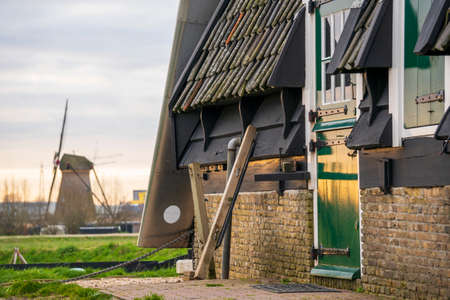 The Green Door of Windmill in Scenic Kinderdijk area of ponds, fields and windmillsの写真素材