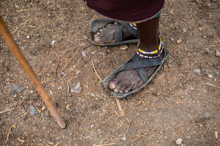 Recycled tires become a Maasai mans sandals in Tanzania, Africaの写真素材