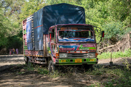 TANZANIA, ARUSHA - JAN 2020: Heavy Cargo Truck Stuck on the Sandy Road in Africa. Putting BranchesUnder Wheels at African Mainland Roads. East Africaのeditorial素材