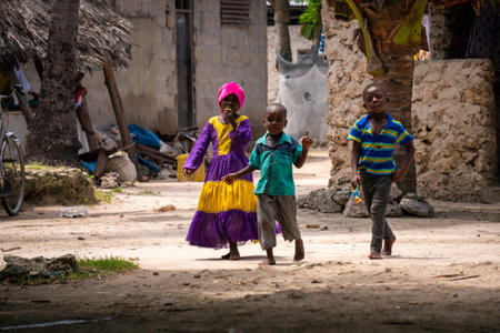 NUNGWI, TANZANIA - January 2020: Nungwi village, Black African Kids on the street of Fisherman Village, Zanzibar, Tanzaniaのeditorial素材