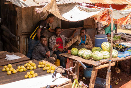 Zanzibar, Tanzania - JANUARY 2020: Black African People Vendors at the Street Fruit and Goods Shop stall Point on Village Streets of Zanzibarのeditorial素材