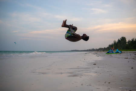 Young Attractive Muscular and Strong Athletic Black African Man at the White Sand Beach Training Body Calisthenicsの写真素材