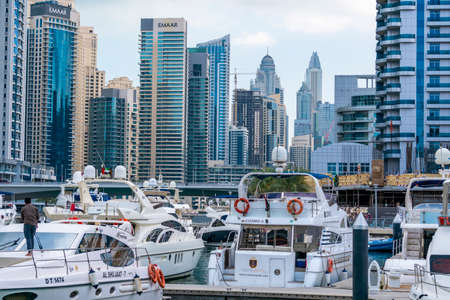 Dubai, UAE - February 2020: Boats in the bay of Dubai Marina with skyscrapers on backgroundのeditorial素材