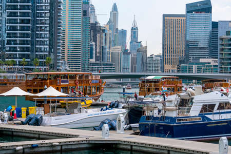 Dubai, UAE - February 2020: Boats in the bay of Dubai Marina with skyscrapers on backgroundのeditorial素材