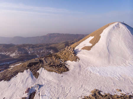 Aerial Drone Sunrise Shot on Mount Nemrud: ancient Antiochia god statues where heads are fallen down from their bodies at Nemrut mountain, Adiyaman, Turkeyの写真素材