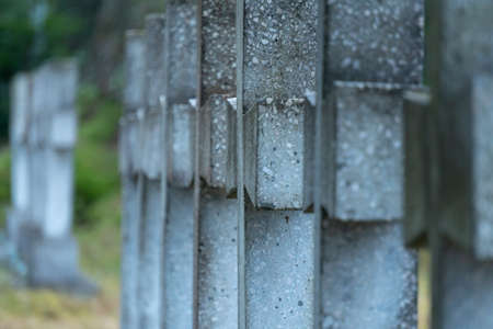 A close up on an old cross being one of many in the row of historic crosses in the middle of a war cemetery standing on one of the monuments in Ukraineの写真素材