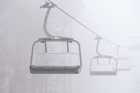 Ski lift in the fog. Ski resort in Bukovel, Ukraineの写真素材