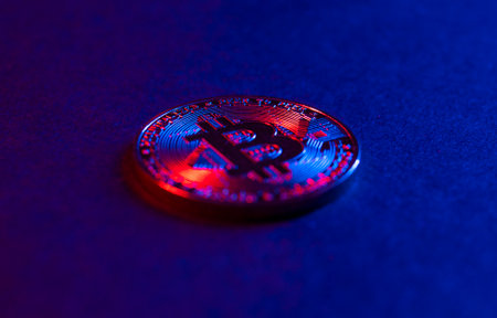 The coin of Bitcoin are on a dark Surface. Purple and pink neon lightの写真素材