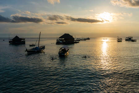 Boats at sunset in Indian Ocean in Zanzibar, Tanzaniaの写真素材
