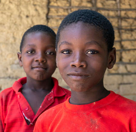 Pemba Island, Zanzibar, Tanzania - January 2020 : Young Cheerful African Kids in remote village Near their Basic Poor Homeのeditorial素材