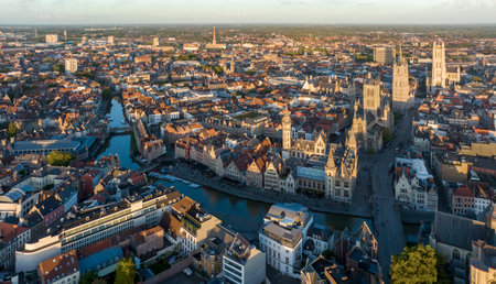 Ghent Belgium Aerial Flying over downtown area with church cityscape views at sunset time - October 2022の写真素材