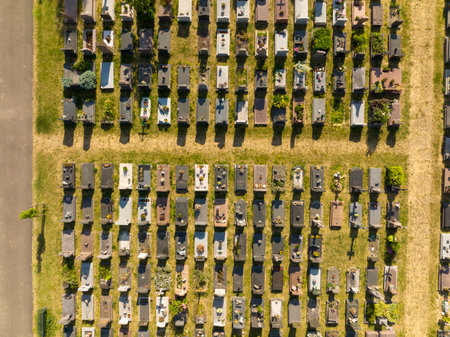 Top view on a Cemetery in Strasbourg. Aerial view at Graves at sunny day. Pattern of tombs and grave trailsの写真素材