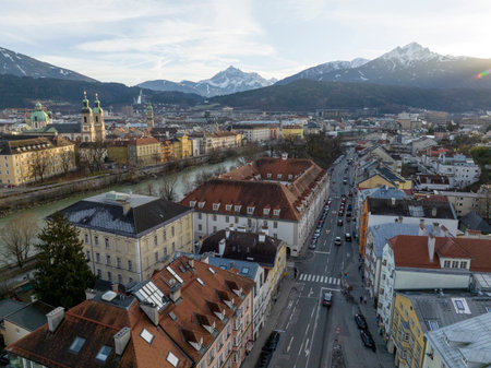 Innsbruck at evening, Aerial Drone Shot of a Beautiful winter City Skyline, Surrounded by Alps Mountains in Austriaの写真素材