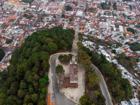 Aerial Drone shot of Church Iglesia de San Cristobalito on the mountain in San Cristobal de Las Casas, Chiapas, Mexicoの写真素材