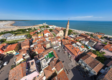 Aerial shot of a Caorle, the Resort sea beach city near to Venice. Red roofs, bright buildings in a...