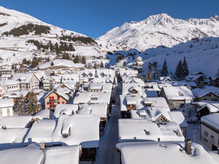 Flight over the famous village of Andermatt in Switzerland in winter - aerial photographyの写真素材