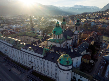 Innsbruck at evening, Aerial Drone Shot of a Beautiful winter City Skyline, Surrounded by Alps Mountains in Austriaの写真素材