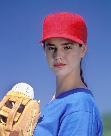 young woman baseball player ready to pitch