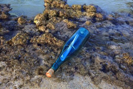 message in a bottle washed ashoreの写真素材