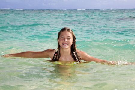 teenage girl in the ocean in hawaiiの写真素材
