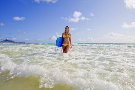 beautiful teenage girl with boogieboard at kailua beach, hawaiiの写真素材