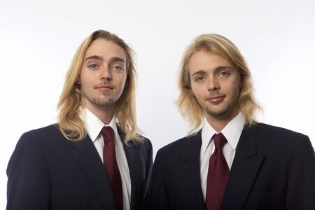 portrait of twin brothers in coat and tieの写真素材