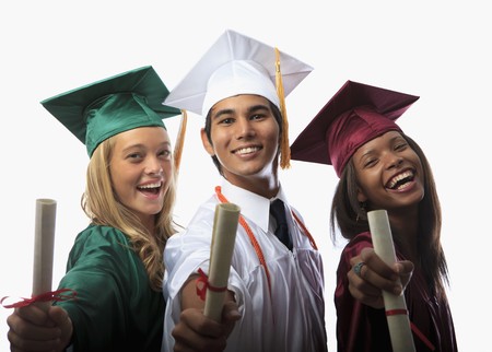 three graduates in cap and gown with diplomas