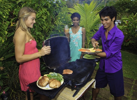 three friends at a barbecue party in hawaii