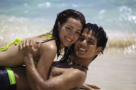 couple playing at the beach in hawaii