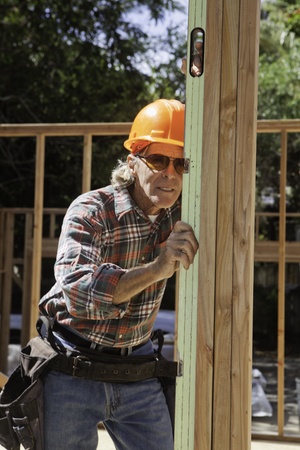 male construction worker building a house