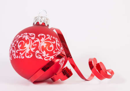 Red bauble with the ribbon on the white backgroundの写真素材