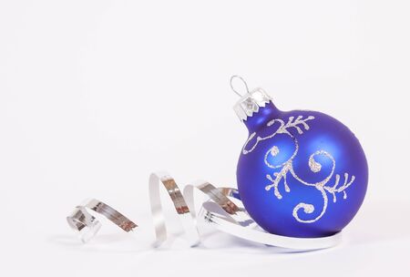 Blue bauble with the silver ribbon on the white backgroundの写真素材