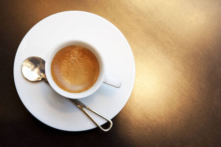 cup of hot coffee with steel spoonの写真素材