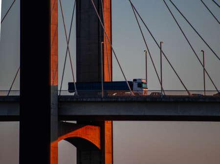 Truck going over a bridge at sunsetの写真素材