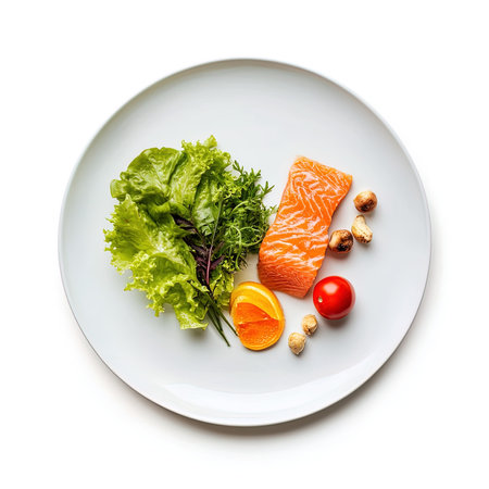 Salmon fillet and vegetables on white plate isolated on white backgroundの写真素材