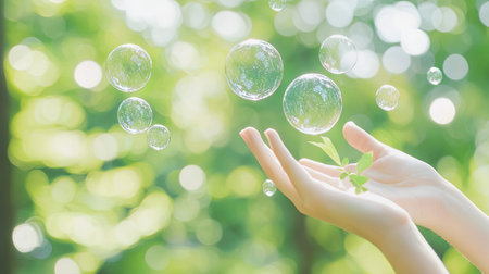 Woman hand holding soap bubbles with green bokeh background, Ecology concept