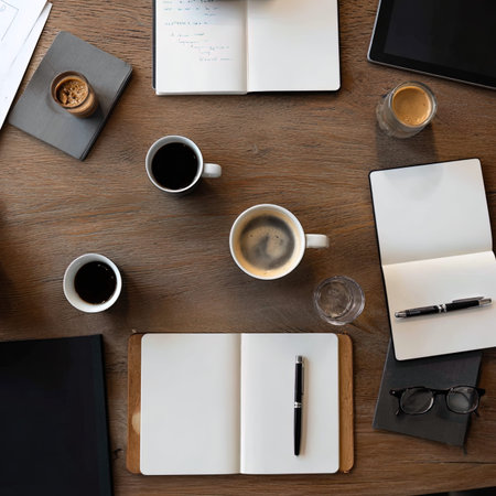 Top view of office table with notepad, coffee cup and other itemsの写真素材