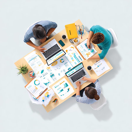 business, people and technology concept - top view of creative team with laptop computers and...