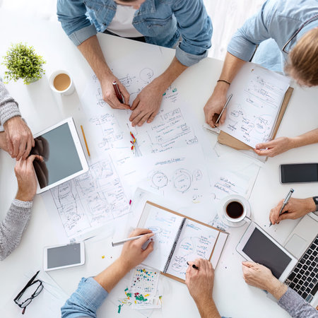 Top view of business people sitting at table and working together in office