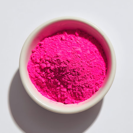 pink holi powder in bowl isolated on white background, top viewの写真素材