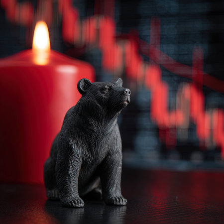 Black bear on the background of a red candle and a stock chartの写真素材