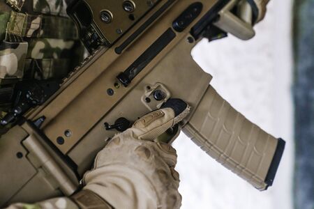 Detailed drawing of a Scar-l assault rifle. Military holding an assault rifle. Multicam camouflage....